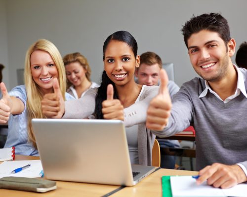Students In Class Holding Thumbs Up